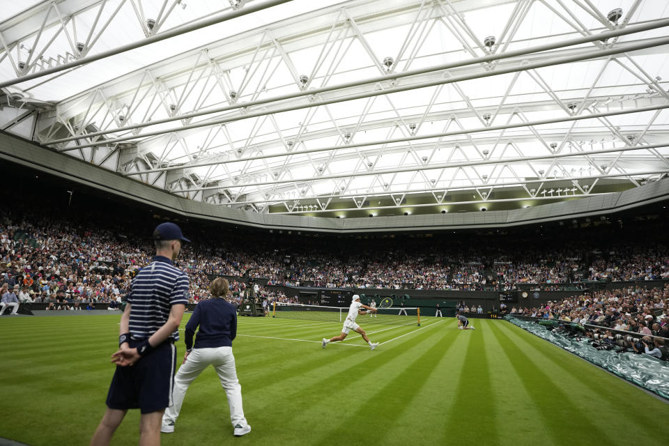 Britain's Ryan Peniston plays a return to Britain's Andy Murray under the Centre Court roof during a first round men's singles match on day two of the Wimbledon tennis championships in London, Tuesday, July 4, 2023. (AP Photo/Alastair Grant)