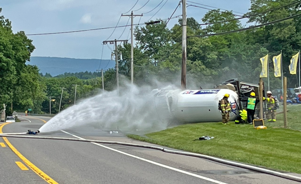 Firefighters spray water on an overturned propane tanker truck on Leitersburg Pike on Wednesday afternoon to prevent a vapor explosion. The crash closed the road between Clopper and Lehman's Mill roads.
