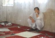 A family member of a slain victim mourns after arriving at the Imam Ali mosque, the site of a suicide bomb attack, in the village of al-Qadeeh in the eastern province of Gatif, Saudi Arabia, May 22, 2015. REUTERS/Stringer