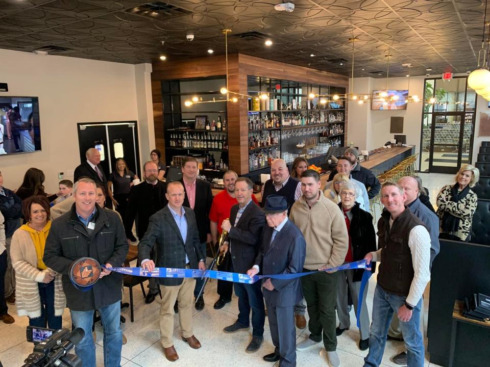 The Narrow Bar, 1500 Broadway. Holding scissors is McDougal Companies CEO Marc McDougal. Holding ribbon are Chamber Ambassadors Rhett Dawson, left, and Garrett Couts. Others pictured are First United Bank CEO Mark Bain; Sr. VP Dan Lewis; Newk’s VP Mark Reedy; Regional Director of Franchise Relations Odair Ferro; Newk’s GM Chris Crooks; Narrow Bar Manager Tim Abascal; Operating Manager Buddy Beach; Sr. VP Tyler McDougal; decorator Tiffany Walker; general contractor/ VP multi-family housing Andy Clayton; and other family, friends and Lubbock Chamber Ambassadors.