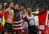 Rico Freimuth of Germany, Ashton Eaton from the U.S. and Damian Warner (L-R) of Canada react after the men's decathlon during the 15th IAAF World Championships at the National Stadium in Beijing, China August 29, 2015. REUTERS/Lucy Nicholson