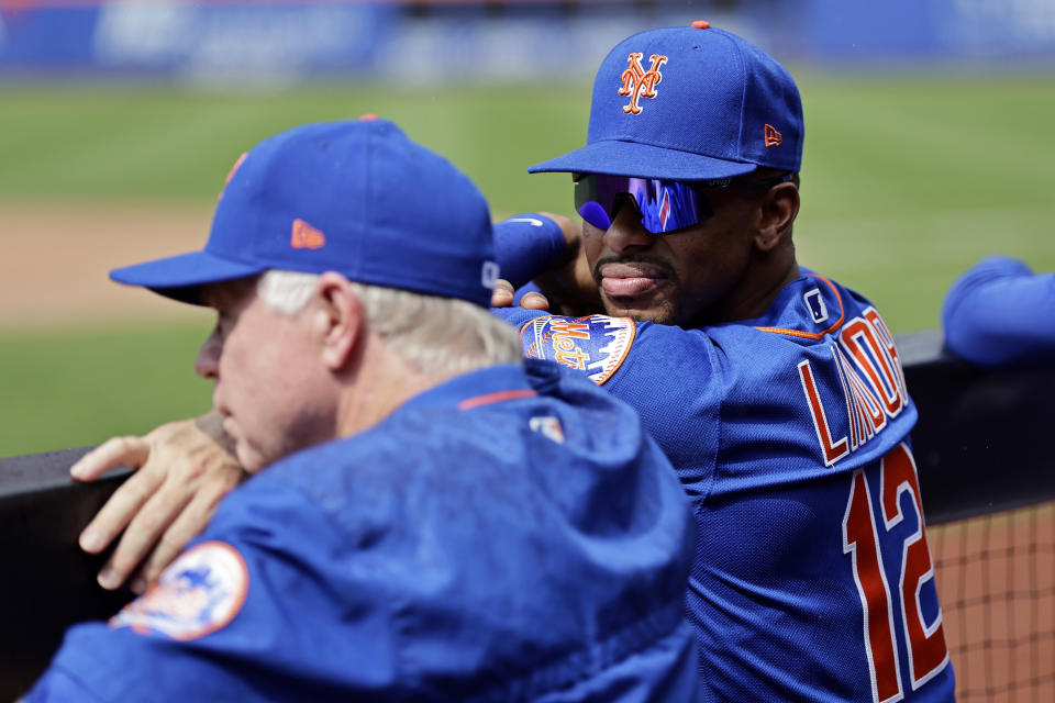 New York Mets shortstop Francisco Lindor talks to manager Buck Showalter against the Atlanta Braves during the sixth inning in the first baseball game of a doubleheader on Saturday, Aug. 12, 2023, in New York. (AP Photo/Adam Hunger)