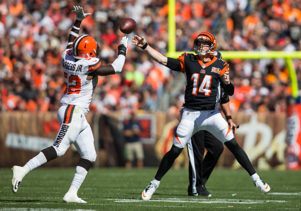 <p>Cincinnati Bengals quarterback Andy Dalton (14) completes a pass under pressure from Cleveland Browns inside linebacker James Burgess (52) during the first quarter at FirstEnergy Stadium. Mandatory Credit: Scott R. Galvin-USA TODAY Sports </p>