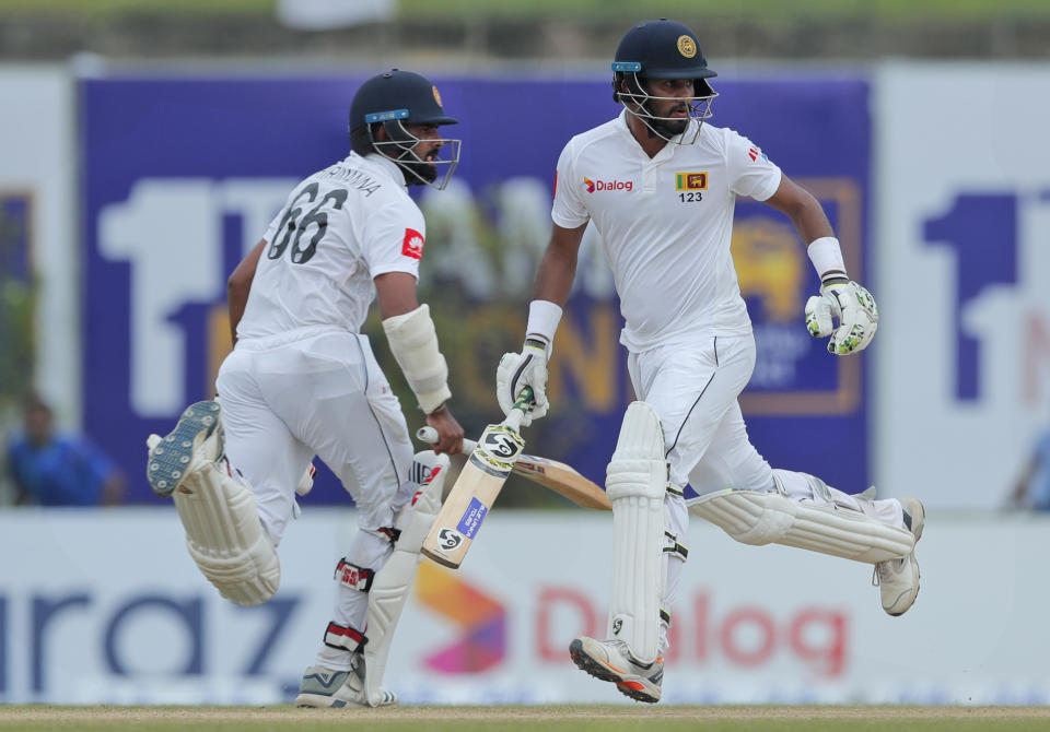 Sri Lanka's Dimuth Karunaratne, right, and Lahiru Thirimanne run between wickets during the fourth day of the first test cricket match between Sri Lanka and New Zealand in Galle, Sri Lanka, Saturday, Aug. 17, 2019. (AP Photo/Eranga Jayawardena)