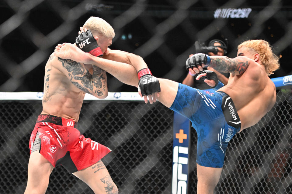 Jan 20, 2024; Toronto, Canada, USA; Serhiy Sidey (red glove) fights Ramon Taveras (blue gloves) during UFC 297 at ScotiaBank Arena. Mandatory Credit: Dan Hamilton-USA TODAY Sports