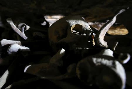 A skull and bones are seen inside a recently discovered burial shaft near Egypt's Saqqara necropolis, in Giza Egypt July 14, 2018. REUTERS/Mohamed Abd El Ghany