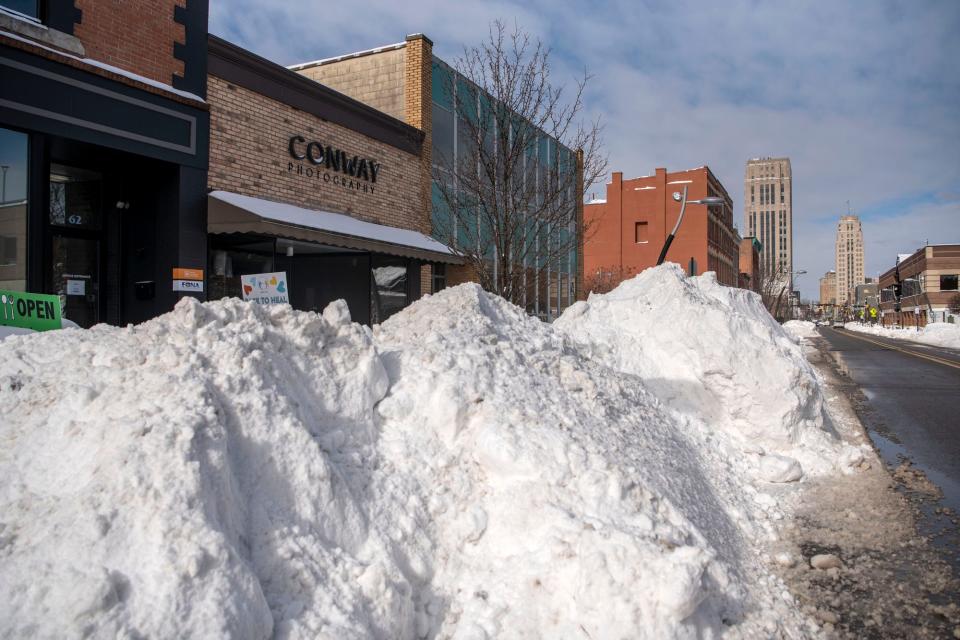 Snow is plowed to the side of Michigan Avenue on Feb. 16, 2021 in Battle Creek, Mich. The city could see 6 to 10 inches of snow this weekend as part of a major winter storm.