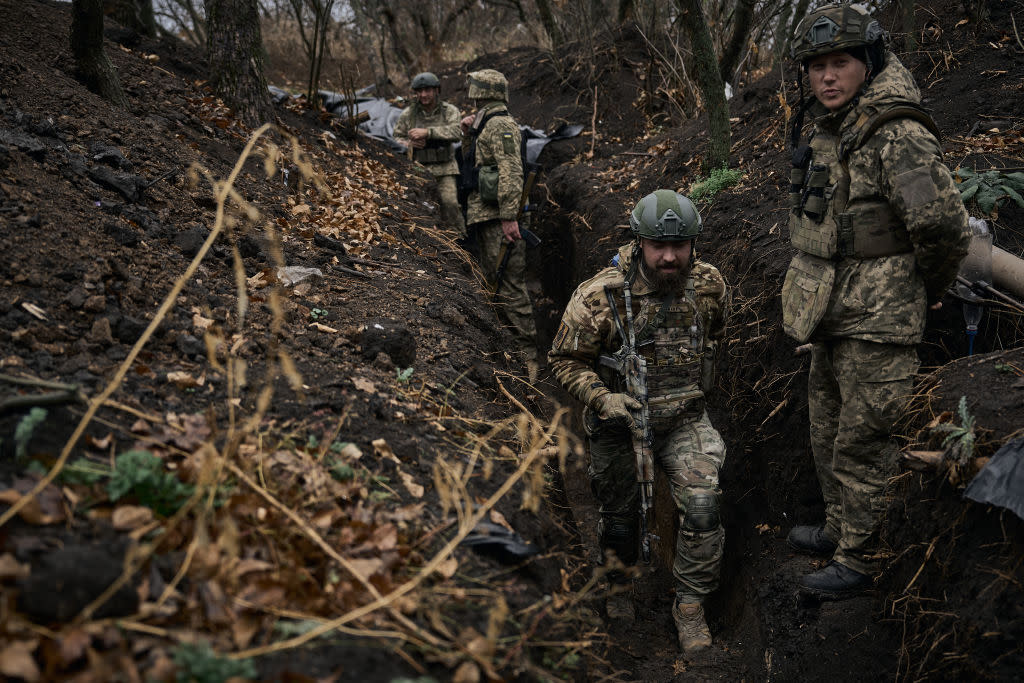  Ukrainian soldiers along trenches, which are covered in mud after the rain on November 6, 2023 in Vuhledar, Ukraine. 