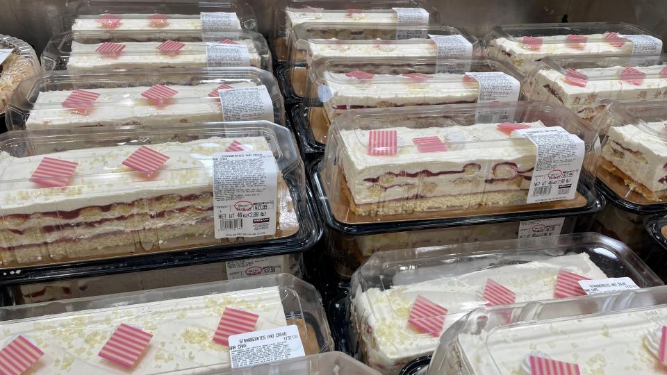 Display of rectangular strawberry and cream cakes in plastic containers at a Costco