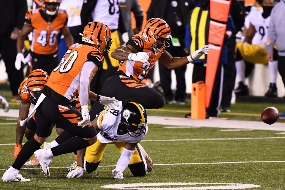 CINCINNATI, OHIO - DECEMBER 21: Vonn Bell #24 of the Cincinnati Bengals forces a fumble by JuJu Smith-Schuster #19 of the Pittsburgh Steelers during the first quarter at Paul Brown Stadium on December 21, 2020 in Cincinnati, Ohio. (Photo by Jamie Sabau/Getty Images)