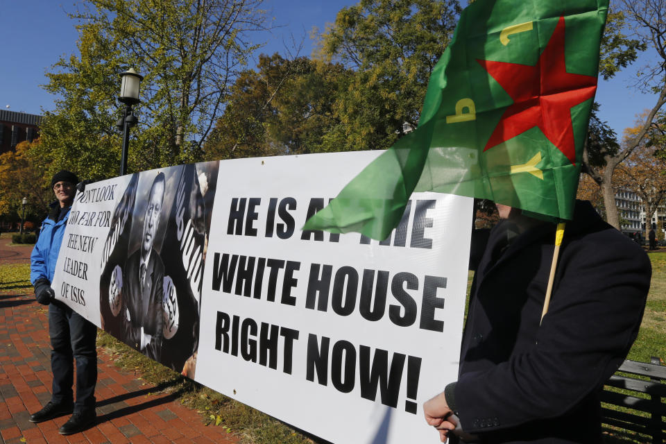 A small group of protesters hold signs as they prepare for a rally against Turkish President Recep Tayyip Erdogan at Lafayette Square park in front of the White House in Wednesday, Nov. 13, 2019, in Washington. (AP Photo/Steve Helber)