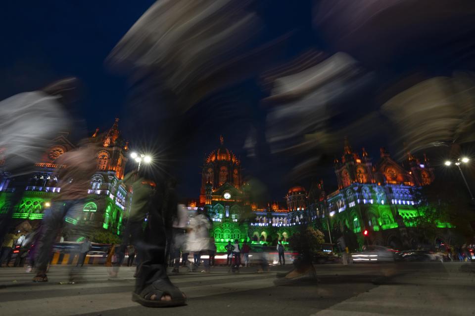 City landmark Chatrapati Shivaji Maharaj terminus building is lit in the colors of the Indian flag on the eve of Independence Day in Mumbai, India, Monday, Aug. 14, 2023. (AP Photo/Rafiq Maqbool)