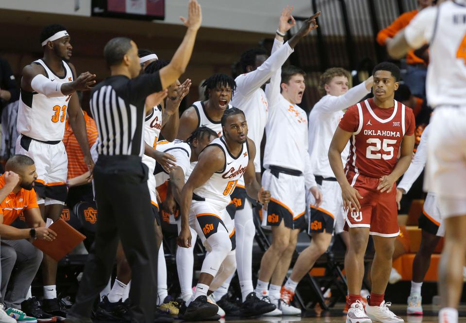 Oklahoma State's John-Michael Wright (51) celebrates beside OU's Grant Sherfield (25) after making a 3-pointer during a game at Gallagher-Iba Arena in Stillwater on Jan. 18. OSU won 72-56.