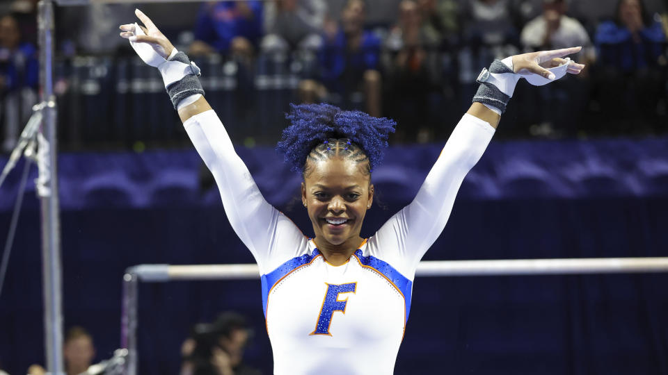 FILE - Florida's Trinity Thomas competes on the uneven bars during an NCAA gymnastics meet against Georgia on Friday, Jan. 27, 2023, in Gainesville, Fla. Thomas, the defending NCAA all-around champion, has 27 perfect 10s in her career, one short of the NCAA record. (AP Photo/Gary McCullough, File)