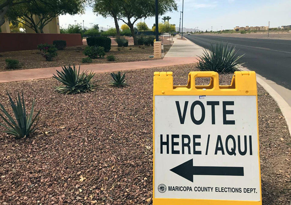 FILE - This April 11, 2018, file photo shows a sign directing voters to an early-voting location in Surprise, Ariz. Sharing the primary calendar Tuesday, March 17, 2020, are two states that represent different pieces of America: Ohio, a largely white state that’s barely growing and looking to rebound from a decline in manufacturing, and Arizona, a state where one-third of the population is Latino and growth is exploding. One looks more like the nation's past, the other could be its future. (AP Photo/Anita Snow, File)