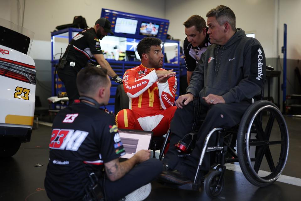Crew chief Bootie Barker (right) speaks with driver Bubba Wallace (center). Both are featured throughout the new Netflix documentary, "NASCAR: Full Speed".