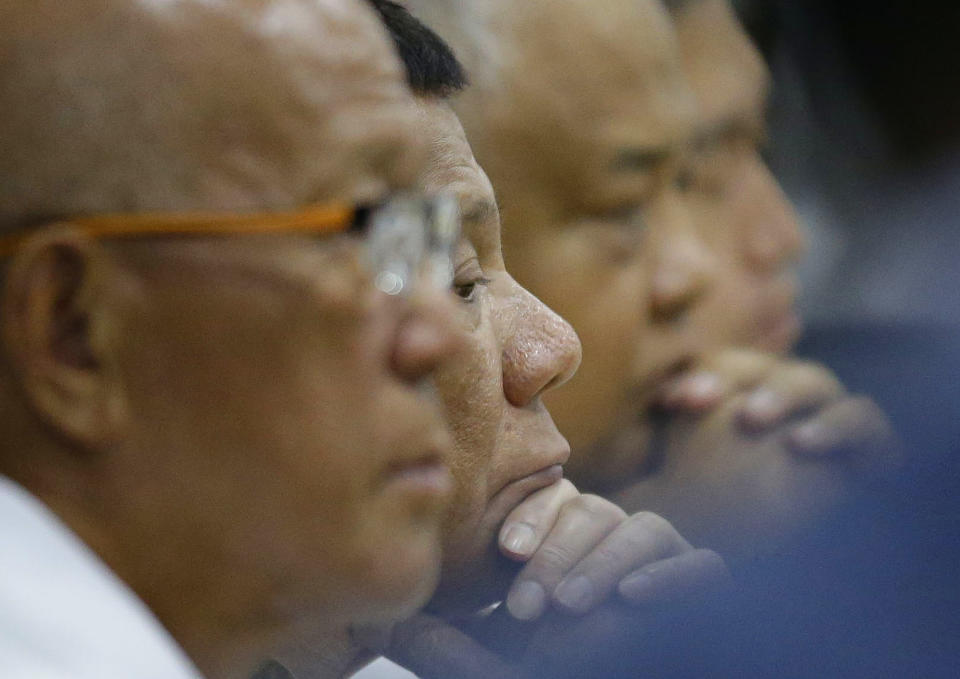 Philippine President Rodrigo Duterte, second from left, attends a command conference on Typhoon Mangkhut, locally named Typhoon Ompong, at the National Disaster Risk Reduction and Management Council operations center in metropolitan Manila, Philippines on Thursday, Sept. 13, 2018. Philippine officials have begun evacuating thousands of people in the path of the most powerful typhoon this year, closing schools and readying bulldozers for landslides. (AP Photo/Aaron Favila)