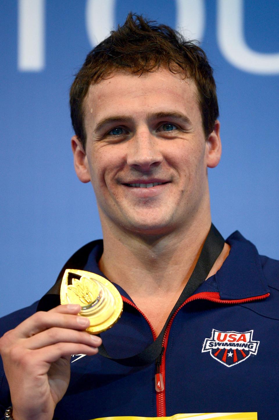 ISTANBUL, TURKEY - DECEMBER 14: Ryan Lochte of USA poses with his Gold medal on the podium after winning the Men's 200m Individual Medley Final during day three of the 11th FINA Short Course World Championships at the Sinan Erdem Dome on December 14, 2012 in Istanbul, Turkey. (Photo by Clive Rose/Getty Images)