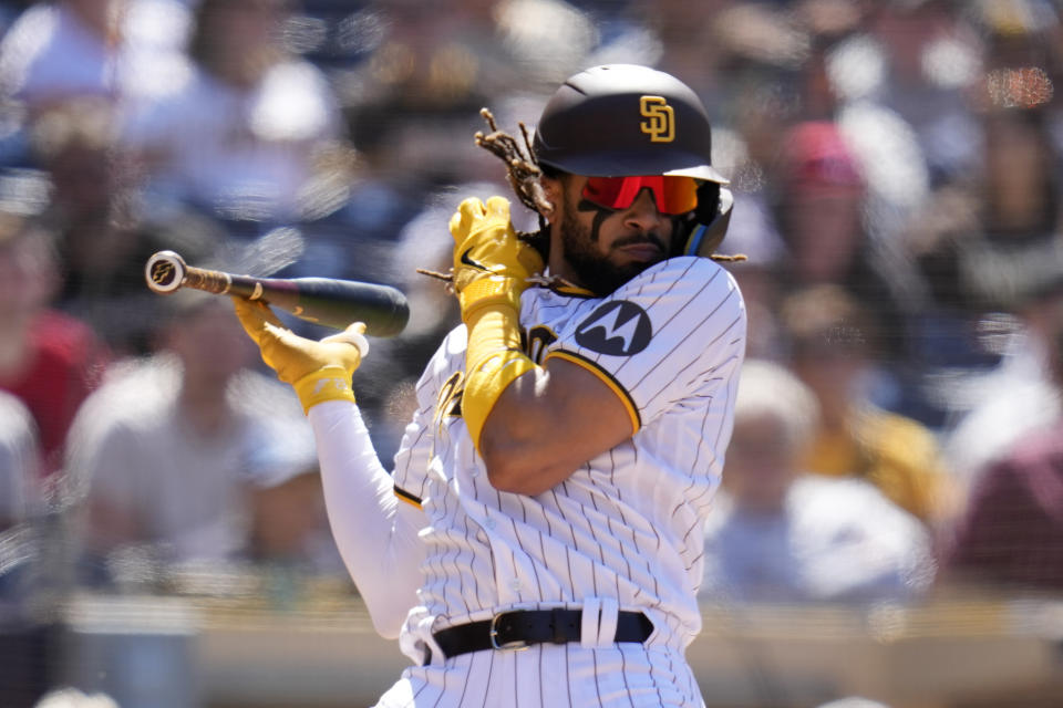 San Diego Padres' Fernando Tatis Jr. moves back from an inside pitch while batting during the sixth inning of a baseball game against the Cincinnati Reds, Wednesday, May 3, 2023, in San Diego. (AP Photo/Gregory Bull)