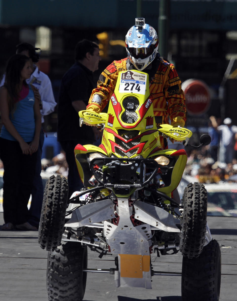 FILE - In this Saturday Jan. 1, 2011 file photo, Argentina's Nicolas Mangiantini, carrying a camera on his helmet, rides his Yamaha quad during the 2011 Argentina-Chile Dakar Rally symbolic start in Buenos Aires, Argentina. For adventure athletes, it's the new essential: a video of their exploits. Now only video action will do for a shoot-it-and-share-it generation of skiers and skydivers, snowboarders and bike riders. (AP Photo/Eduardo Di Baia, File)