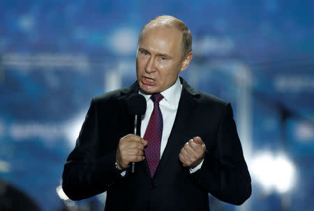 Russian president Vladimir Putin addresses the audience during a rally marking the fourth anniversary of Russia's annexation of Ukraine's Crimea region in the Black Sea port of Sevastopol, Crimea, March 14, 2018. REUTERS/Maxim Shemetov