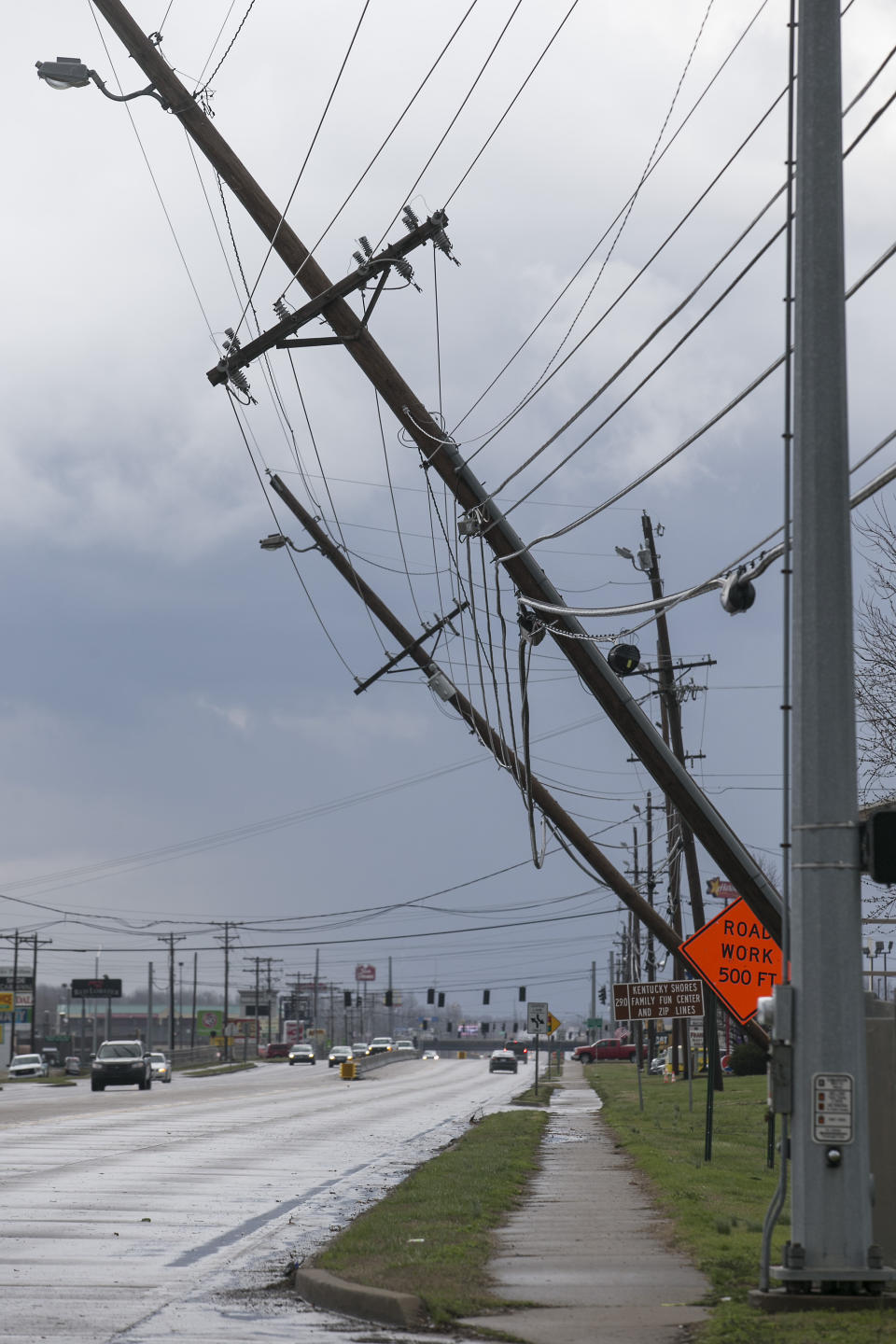 Power lines are down in Paducah, Ky. on Thursday, March 14, 2019. This Thursday, March 14, 2019 photo shows damage to the Wilbert Vault Co., in West Paducah, Ky. A tornado left a path in western Kentucky from Lovelaceville through the West Paducah area, according to Keith Todd, a spokesman for the Kentucky Transportation Cabinet. He said the public was being asked to avoid the area while utility crews, area fire departments, and rescue squads worked to clear utility lines, downed trees and other debris. (Dave Thompson/The Paducah Sun via AP)