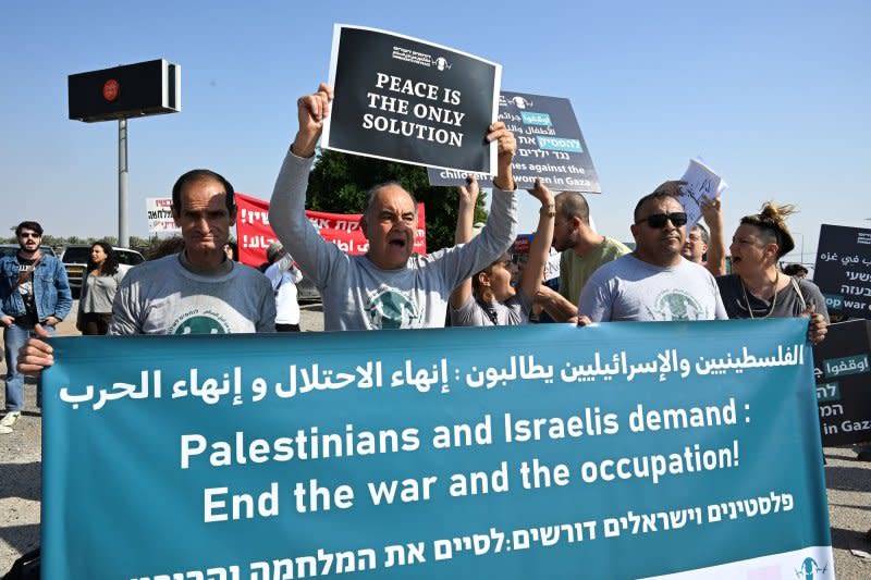 Israelis and Palestinians holds placards and banners with messages calling for an end of the war in Gaza near Jericho, West Bank, on Friday. Texas A&M University on Friday said it plans to shut down its Qatar campus over the next four years due to unrest in the region. Photo by Debbie Hill/UPI