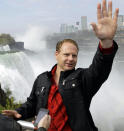 Nik Wallenda waves to tourists after a news conference in Niagara Falls, N.Y., Wednesday, May 2, 2012. Wallenda will try to cross the Niagara Gorge on a tightrope June 15. The seventh-generation member of the Flying Wallendas spent months getting the necessary permissions from Canada and the United States for the cross-border stunt. (AP Photo/David Duprey)