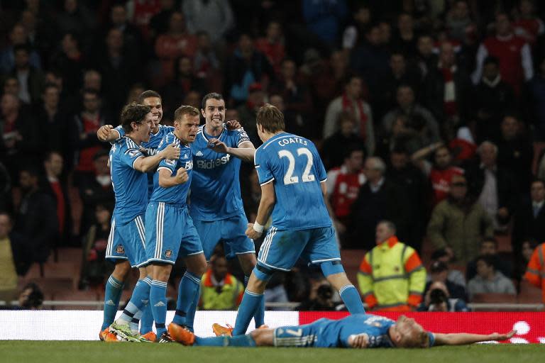 Sunderland's players celebrate at the final whistle of their English Premier League goalless draw with Arsenal, at the Emirates Stadium in London, on May 20, 2015