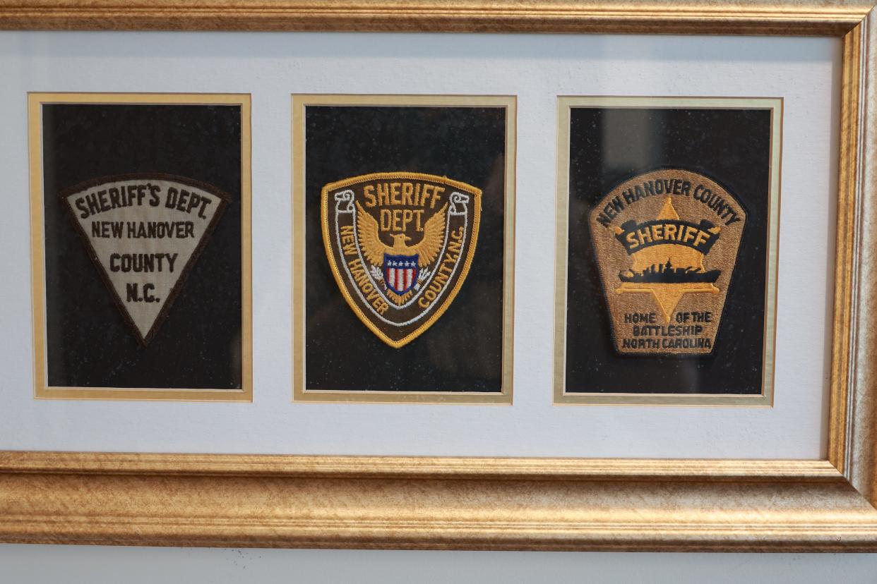 A display in the New Hanover County Sheriff's Office showcasing the evolution of the department's patch overtime.
