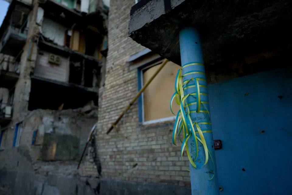 Ribbons in the colors of the Ukraine flag are tied to a building destroyed by attacks in Gorenka, on the outskirts of Kyiv, Ukraine, Wednesday, June 8, 2022. (AP Photo/Natacha Pisarenko) ORG XMIT: XNP504