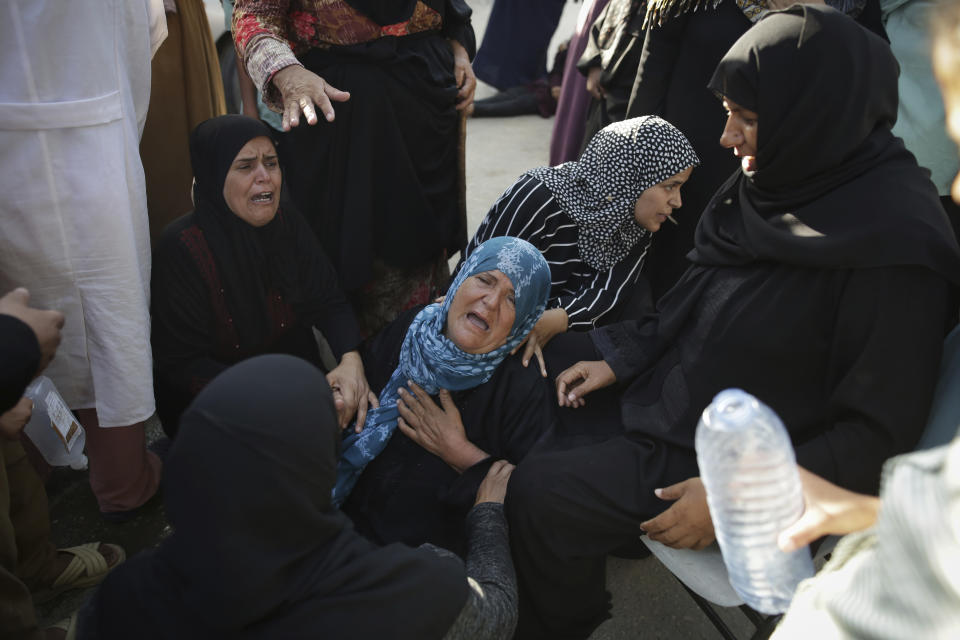 Palestinians mourn their relatives killed in the Israeli bombardment of the Gaza Strip at a hospital morgue in Khan Younis, southern Gaza Strip, Monday, June 24, 2024. (AP Photo/Jehad Alshrafi)