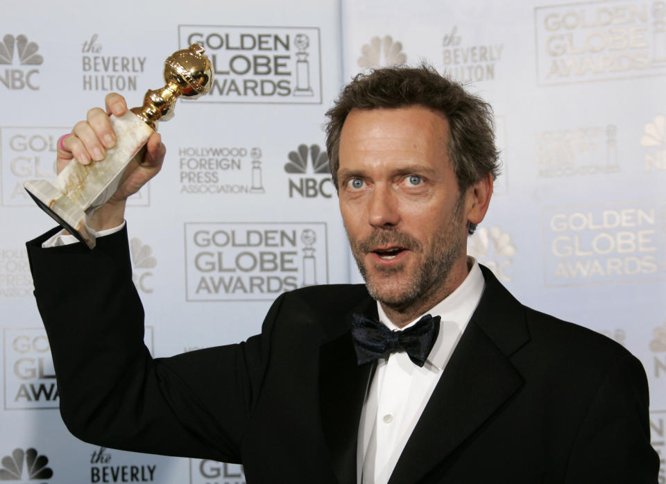 FILE - In this Jan. 15, 2007 file photo, actor Hugh Laurie poses with the award he won for best actor in a drama series for his work on "House," at the 64th Annual Golden Globe Awards in Beverly Hills, Calif. The Fox medical drama concludes its eight-season run on Monday, May 21, 2012, with a finale at 9 p.m. EDT, preceded by a one-hour retrospective. (AP Photo/Kevork Djansezian, file)