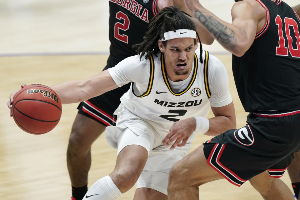 Missouri's Drew Buggs (2) tries to drive through Georgia defenders in the second half of an NCAA college basketball game in the Southeastern Conference Tournament Thursday, March 11, 2021, in Nashville, Tenn. (AP Photo/Mark Humphrey)