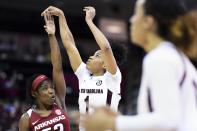 South Carolina guard Zia Cooke , back right, follows through on a shot against Arkansas guard Rokia Doumbia, left, during the first half of an NCAA college basketball game Thursday, Jan. 9, 2020, in Columbia, S.C. (AP Photo/Sean Rayford)