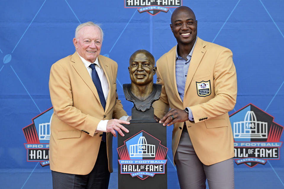 Former NFL player DeMarcus Ware, right, and Dallas Cowboys owner Jerry Jones pose with Ware's bust during his induction into the Pro Football Hall of Fame in Canton, Ohio, Saturday, Aug. 5, 2023. (AP Photo/David Dermer)