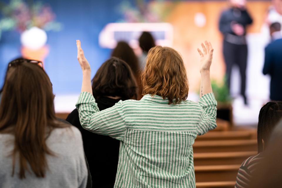 Congregation members hold their hands up during a service at Koinonia Church in Nashville, Tenn., Sunday, April 2, 2023.