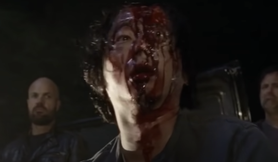 A man's eye bulges out of his head and his face is covered in blood