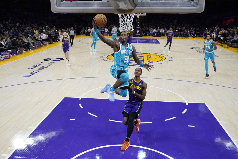 Charlotte Hornets guard Terry Rozier (3) scores past Los Angeles Lakers guard Lonnie Walker IV during the first half of an NBA basketball game Friday, Dec. 23, 2022, in Los Angeles. (AP Photo/Marcio Jose Sanchez)