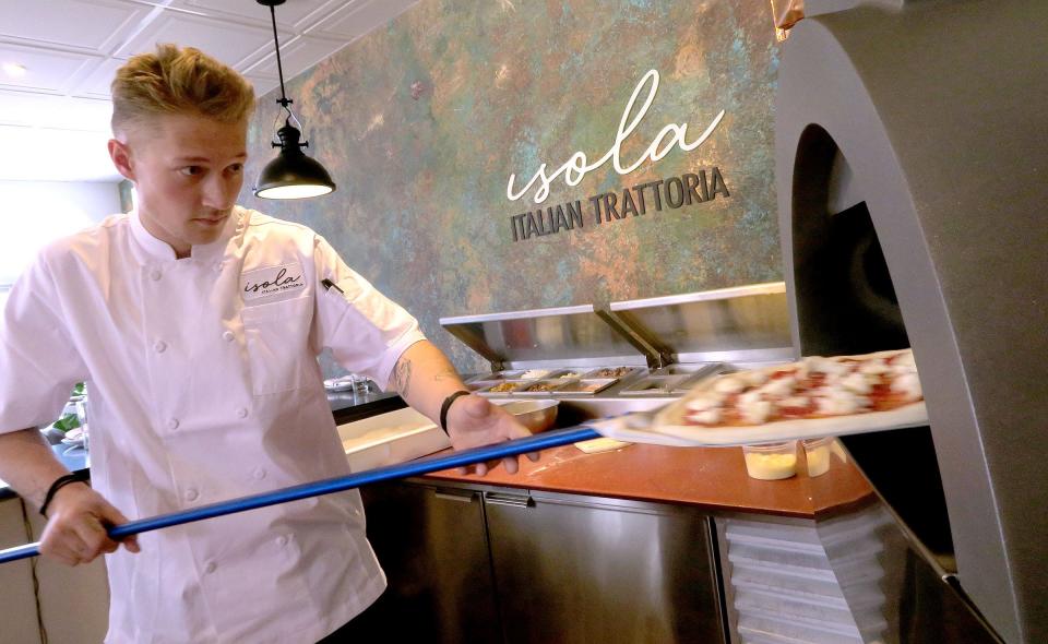 Isola Executive Pizza Chef Dylan Walenciak prepares a pizza in an imported Fiero oven at the new Italian restaurant in Beach Haven.