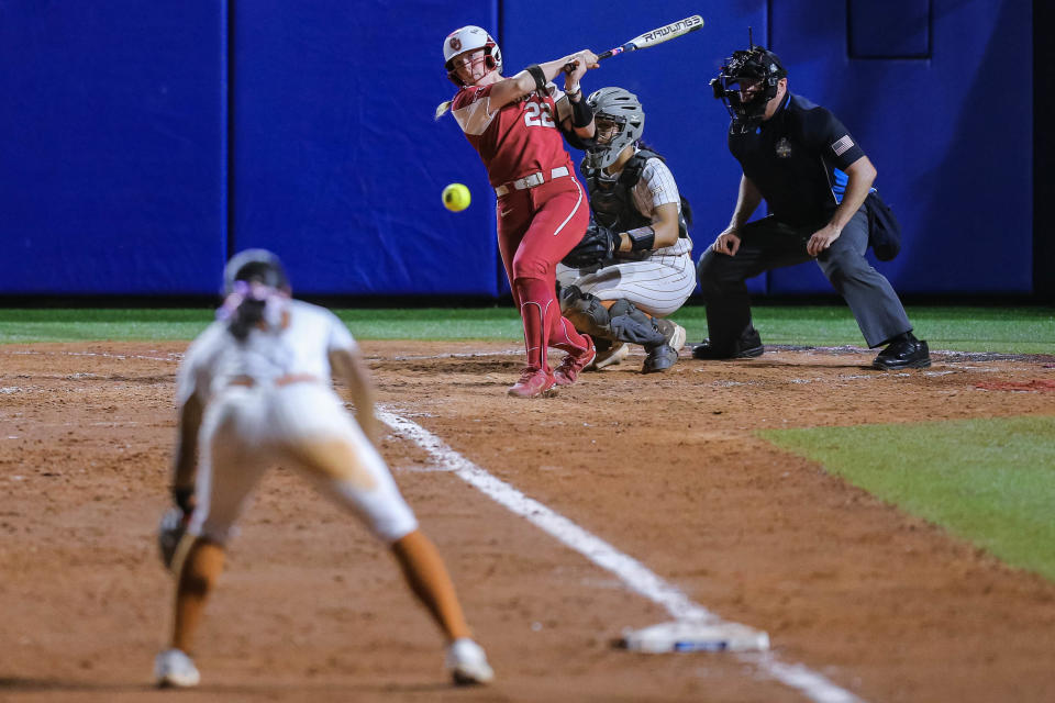 Oklahoma's Lynnsie Elam his a line drive to third base during Wednesday night's 16-1 win over Texas in Game 1 of the best-of-three Women's College World Series in Oklahoma City. The loss forced a do-or-die Game 2 for Texas on Thursday night.