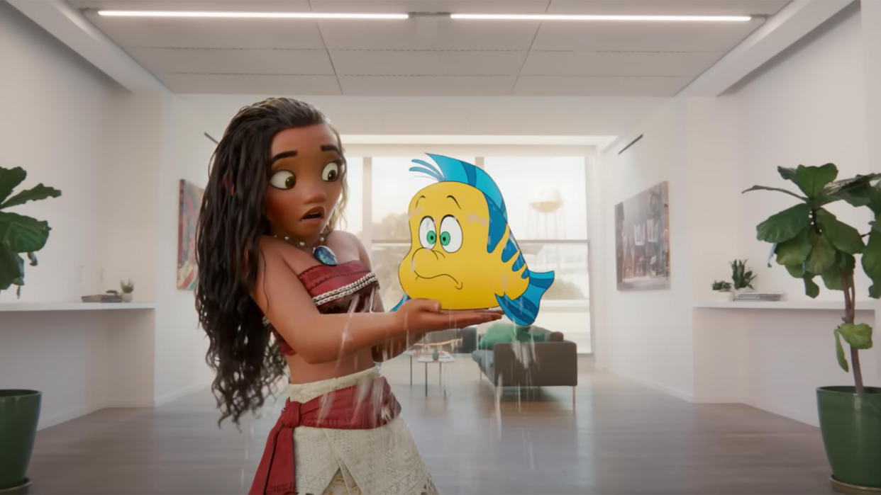  Disney character Moana holding Flounder from The Little Mermaid. 