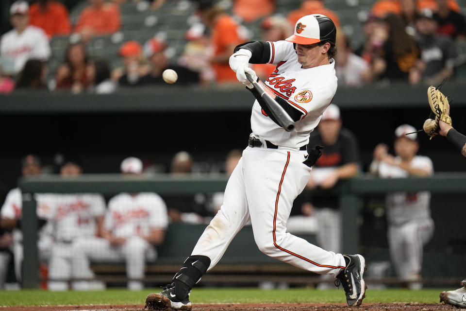 Baltimore Orioles' Adley Rutschman swings at a pitch from the Chicago White Sox during the first inning of a baseball game, Monday, Aug. 28, 2023, in Baltimore. (AP Photo/Julio Cortez)