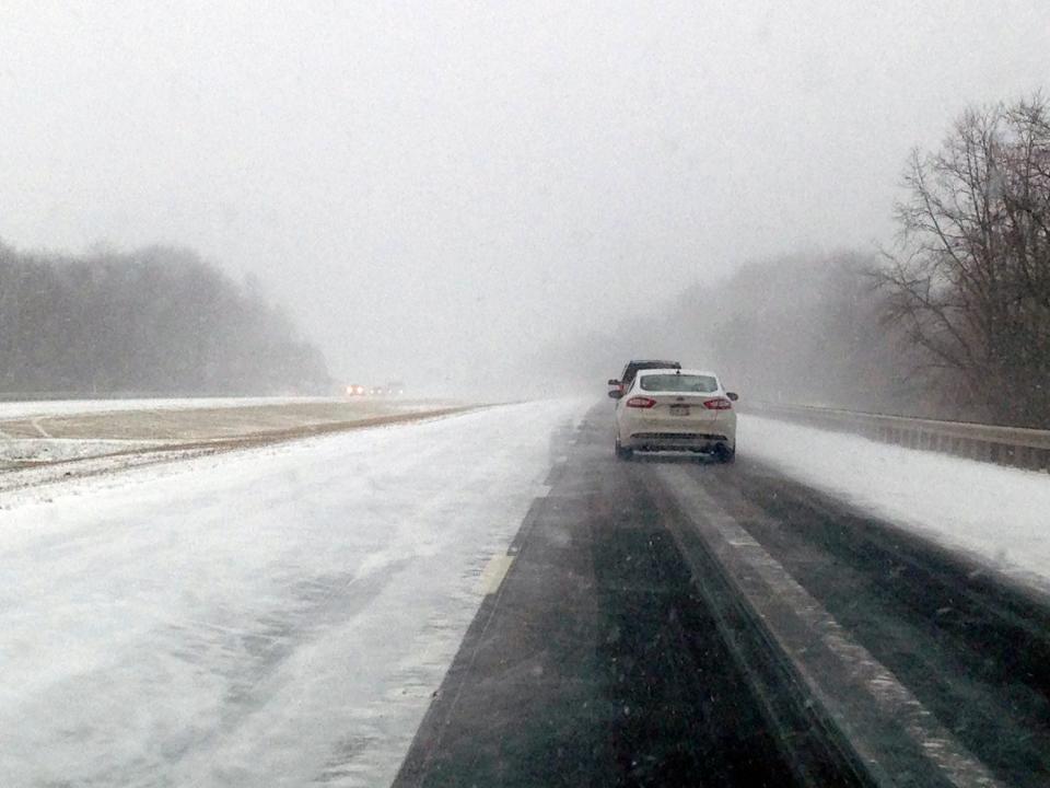 Traffic along Interstate 64 near Lewisburg, W.Va., is reduced to one lane due to blowing snow, Wednesday, Jan. 7, 2015.