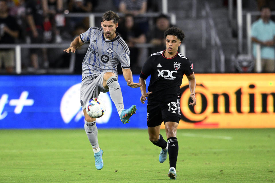 CF Montréal midfielder Matko Miljevic, left, is defended by D.C. United midfielder Sofiane Djeffal (13) during the second half of an MLS soccer match Saturday, July 23, 2022, in Washington. CF Montréal won 2-1. (AP Photo/Nick Wass)