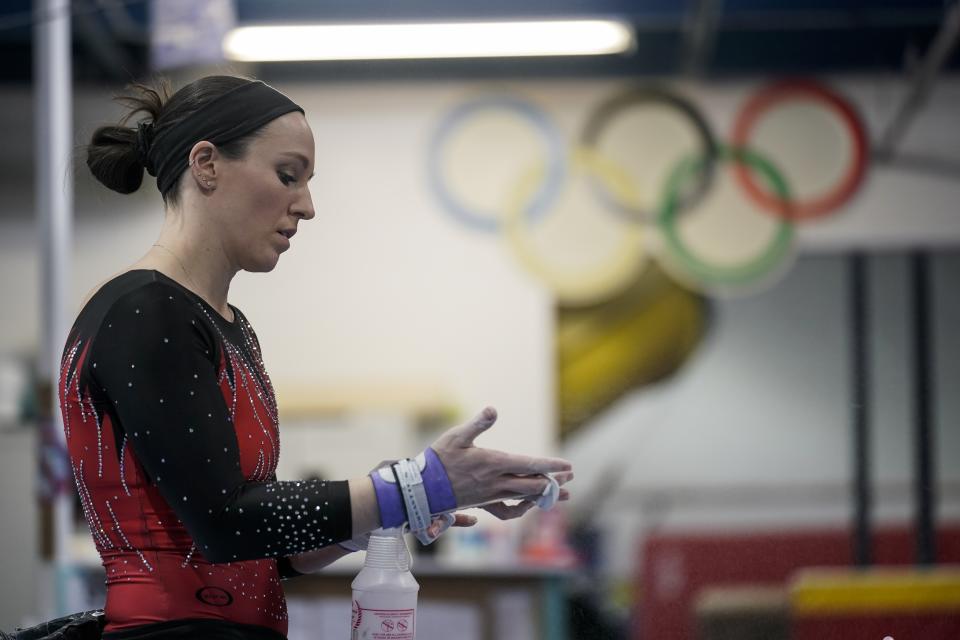 Chellsie Memmel works out Thursday, Feb. 18, 2021, in New Berlin, Wis. Memmel started doing gymnastics again when the COVID-19 pandemic hit last spring because it felt like one of the few things in her life she could control. The 32-year-old former world champion and Olympic silver medalist discovered more than an outlet for stress. (AP Photo/Morry Gash)