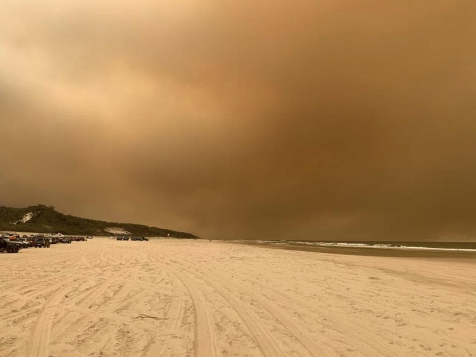 Fraser Island beach is surrounded by thick smoke from nearby bushfires.