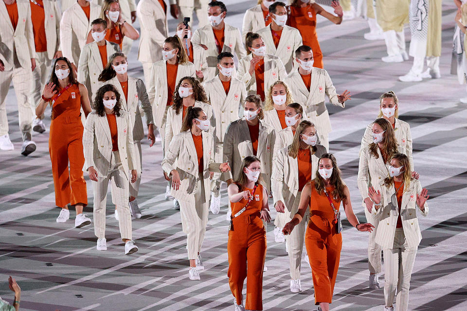 <p>Are the delegates from Netherlands heading to the opening ceremony or to the office? Some delegates wore belted burnt orange (the national color) and cream sleeveless jumpsuits, while others wore pinstripe suits. </p>