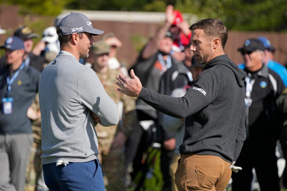 Aaron Rodgers, left, talks with former NFL quarterback Alex Smith before the start of the putting challenge event of the AT&T Pebble Beach Pro-Am golf tournament on Wednesday in Pebble Beach, California. Smith and Rodgers are forever linked from the 2005 NFL draft. Smith was taken No. 1 overall by the San Francisco 49ers, Rodgers' childhood team, while Rodgers fell to the Packers at No. 24.