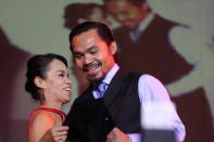 World welterweight boxing champion Manny Pacquiao is seen with his mother Dionisia Pacquiao at the KCC Mall on May 15, 2010 in General Santos, Philippines. Pacquiao was there to celebrate his election on becoming a member of House of Representatives in the 15th Congress of the Philippines. Pacquiao established the record of being the first active boxer to become a congressman in the Philippines. (Photo by Jeoffrey Maitem/Getty Images)